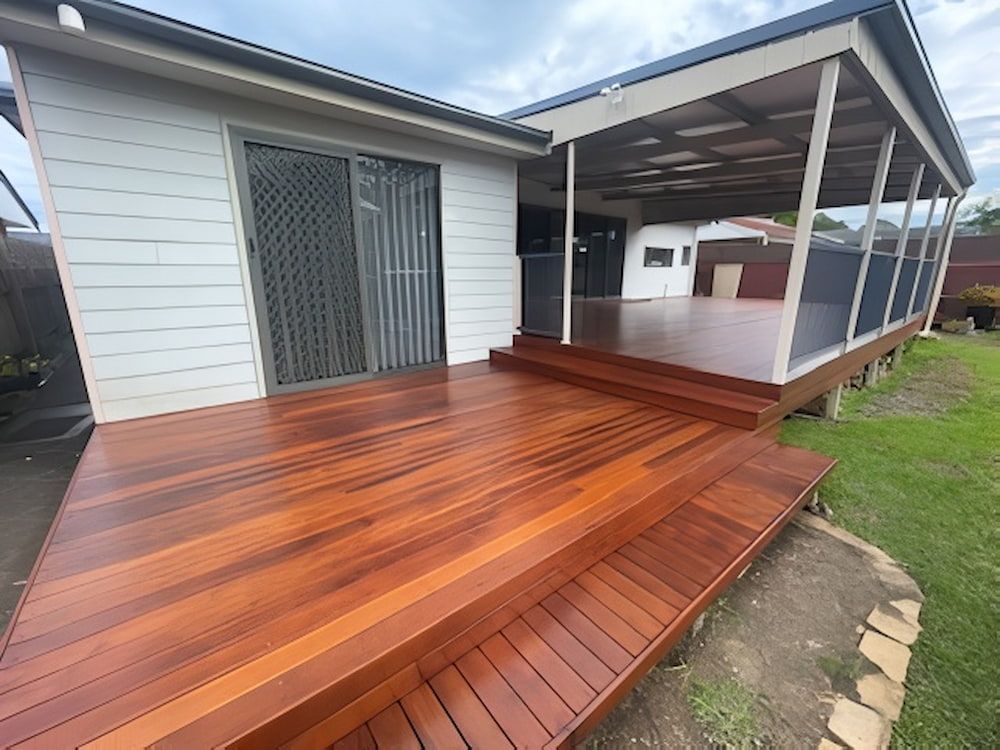 A Wooden Deck is in Front of a House With a Screened in Porch — Cornall Painting Services in Kempsey, NSW