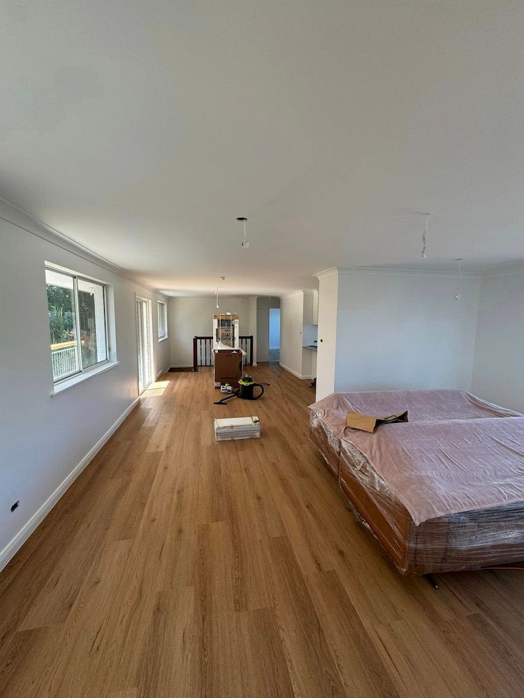 Unfurnished Room With Boxes, Vacuum, and Sunlight — Cornall Painting Services in Wauchope, NSW