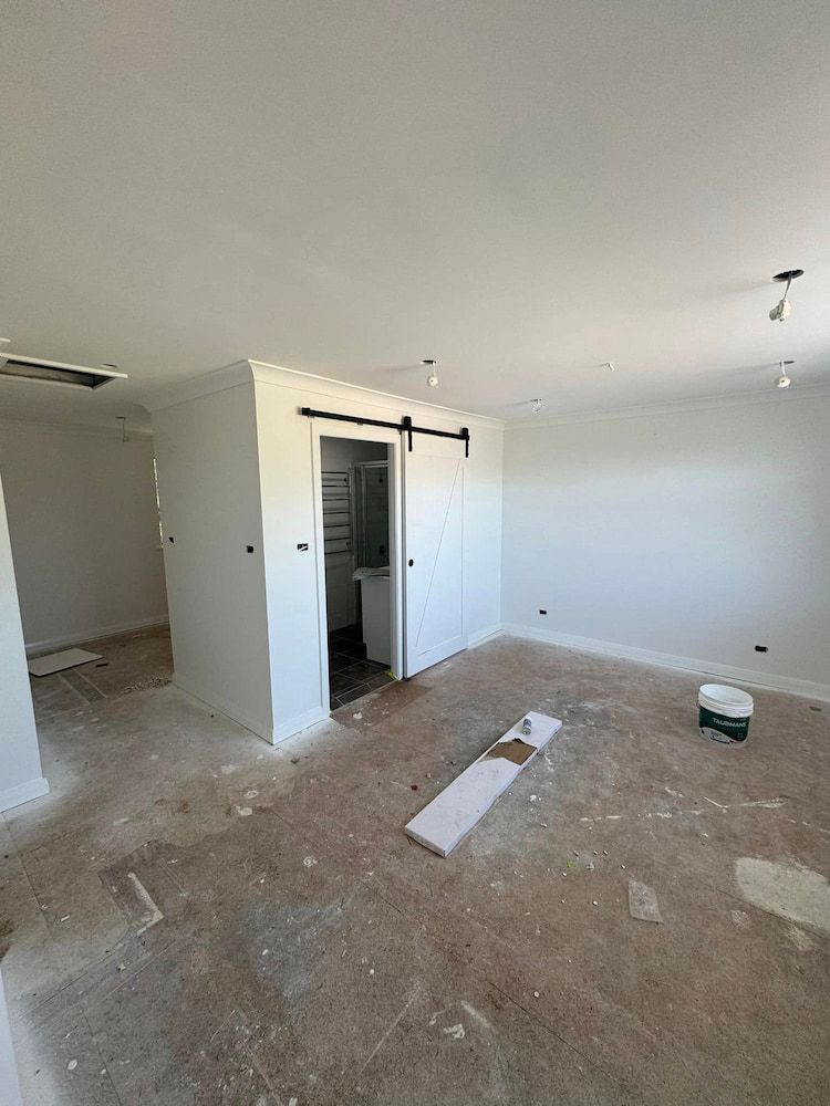 There is a Sliding Barn Door in the Middle of the Room — Cornall Painting Services in Laurieton, NSW