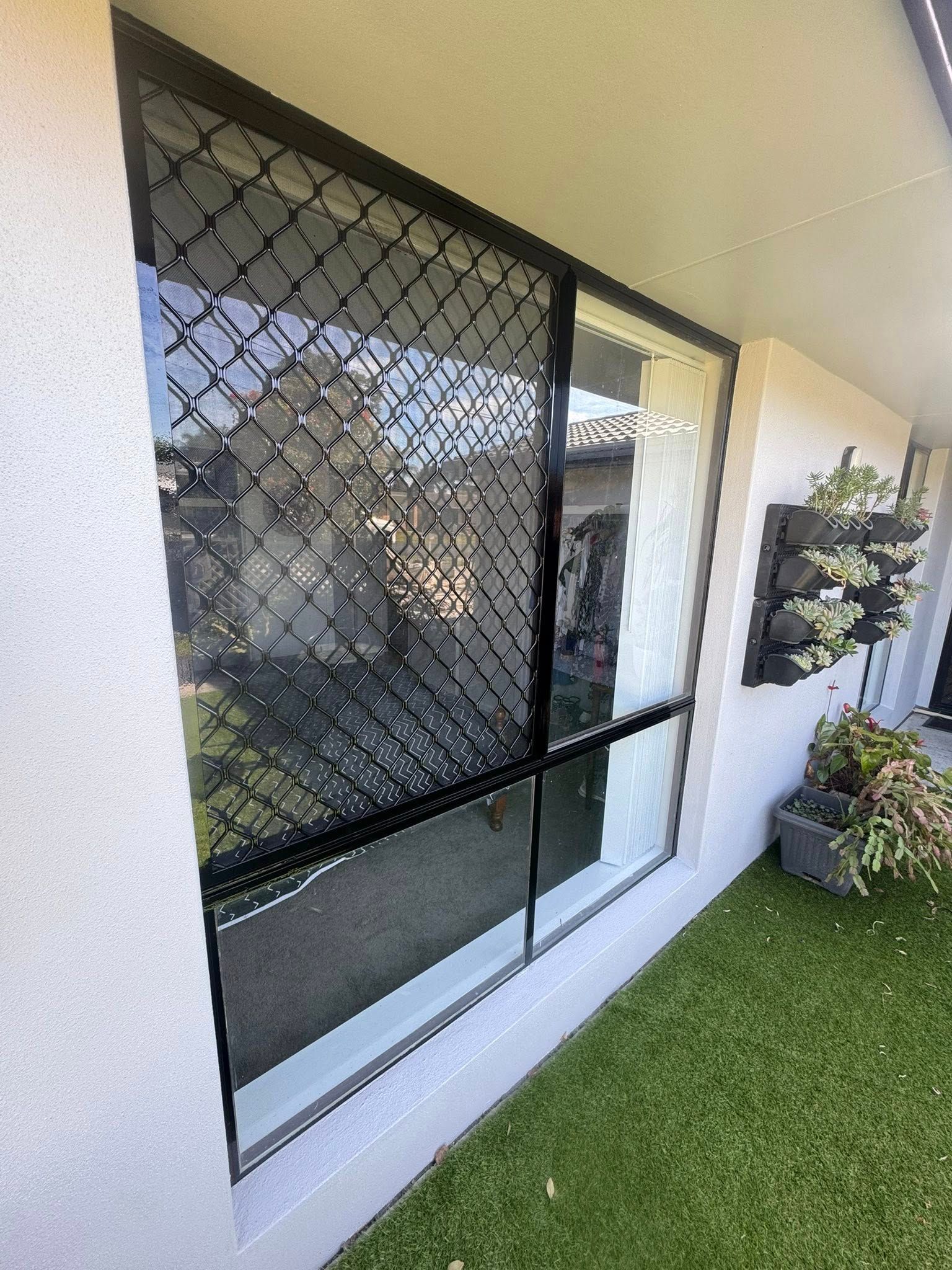 A large two pane window on the wall of a white house - Cornall Painting Services in Wauchope NSW