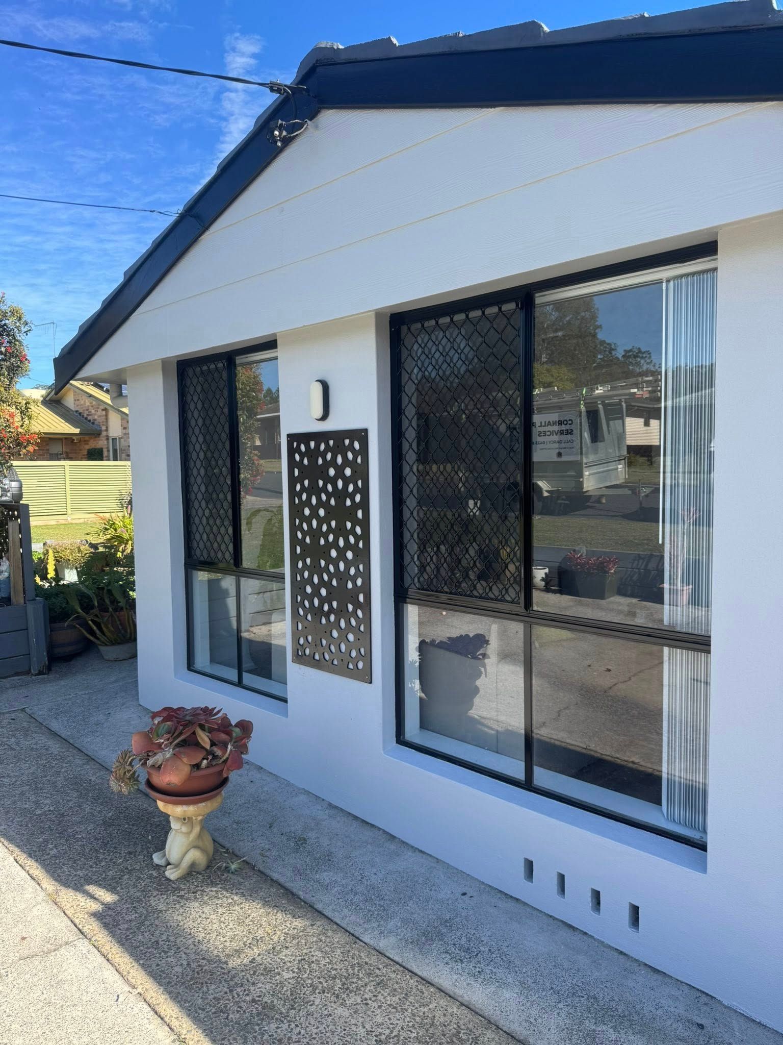 A white house with two aluminium windows - Cornall Painting Services in Wauchope NSW