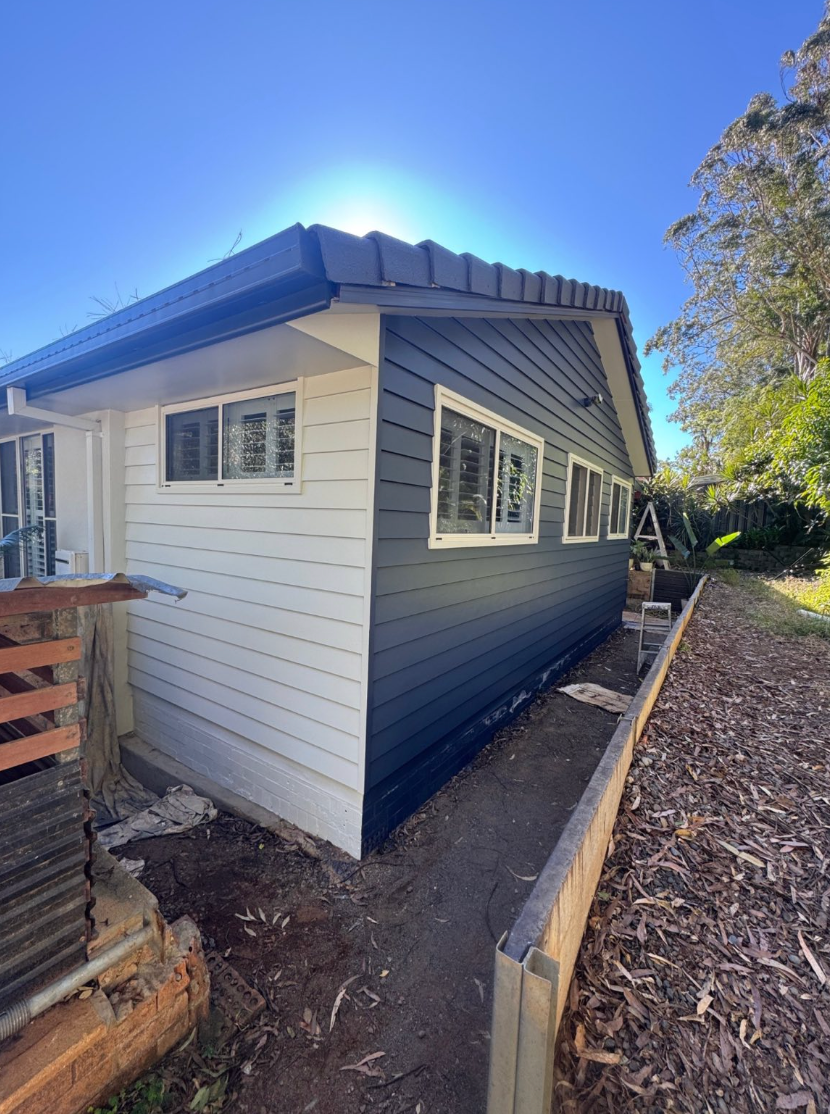 A black and white house with a fence in front of it. — Cornall Painting Services in Wauchope, NSW