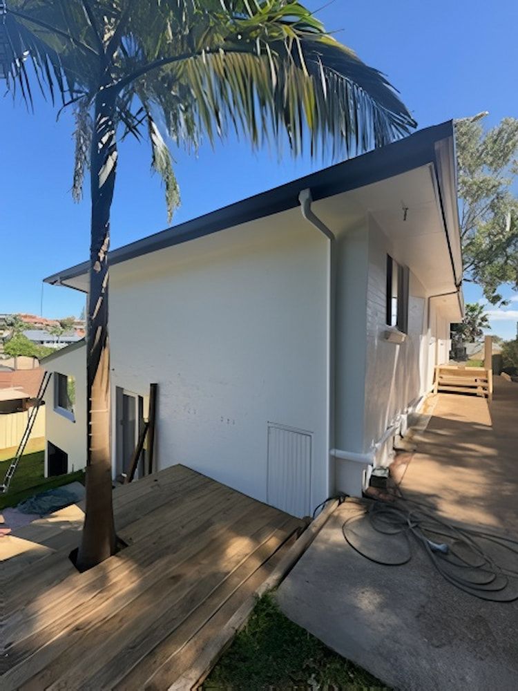 A White House With a Palm Tree in Front of It — Cornall Painting Services in Kempsey, NSW