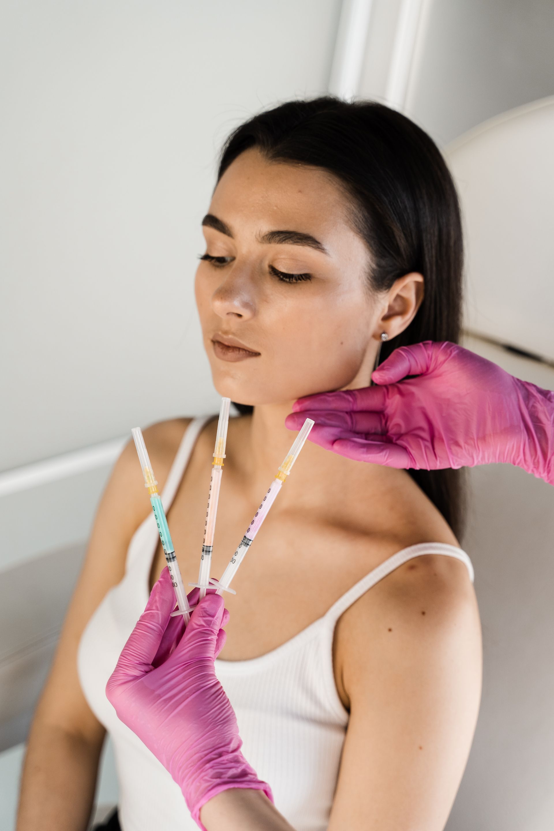 a woman is getting an injection in her face in a beauty salon .