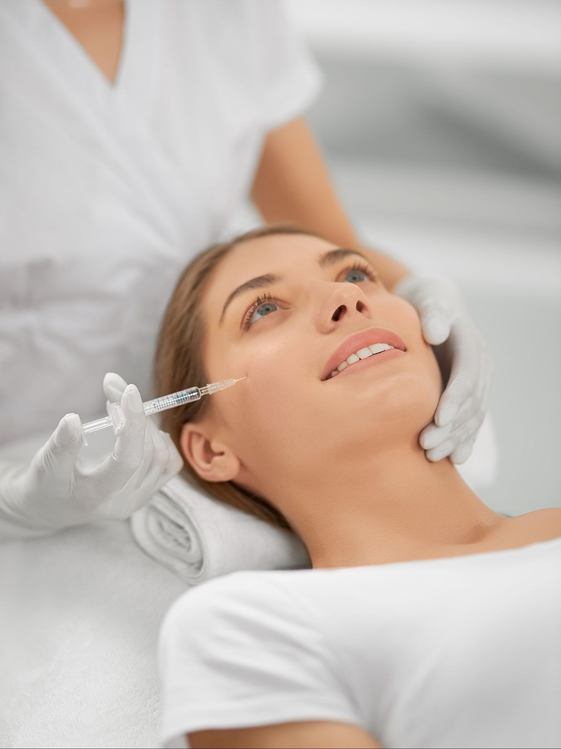 a woman is getting an injection in her face in a beauty salon .