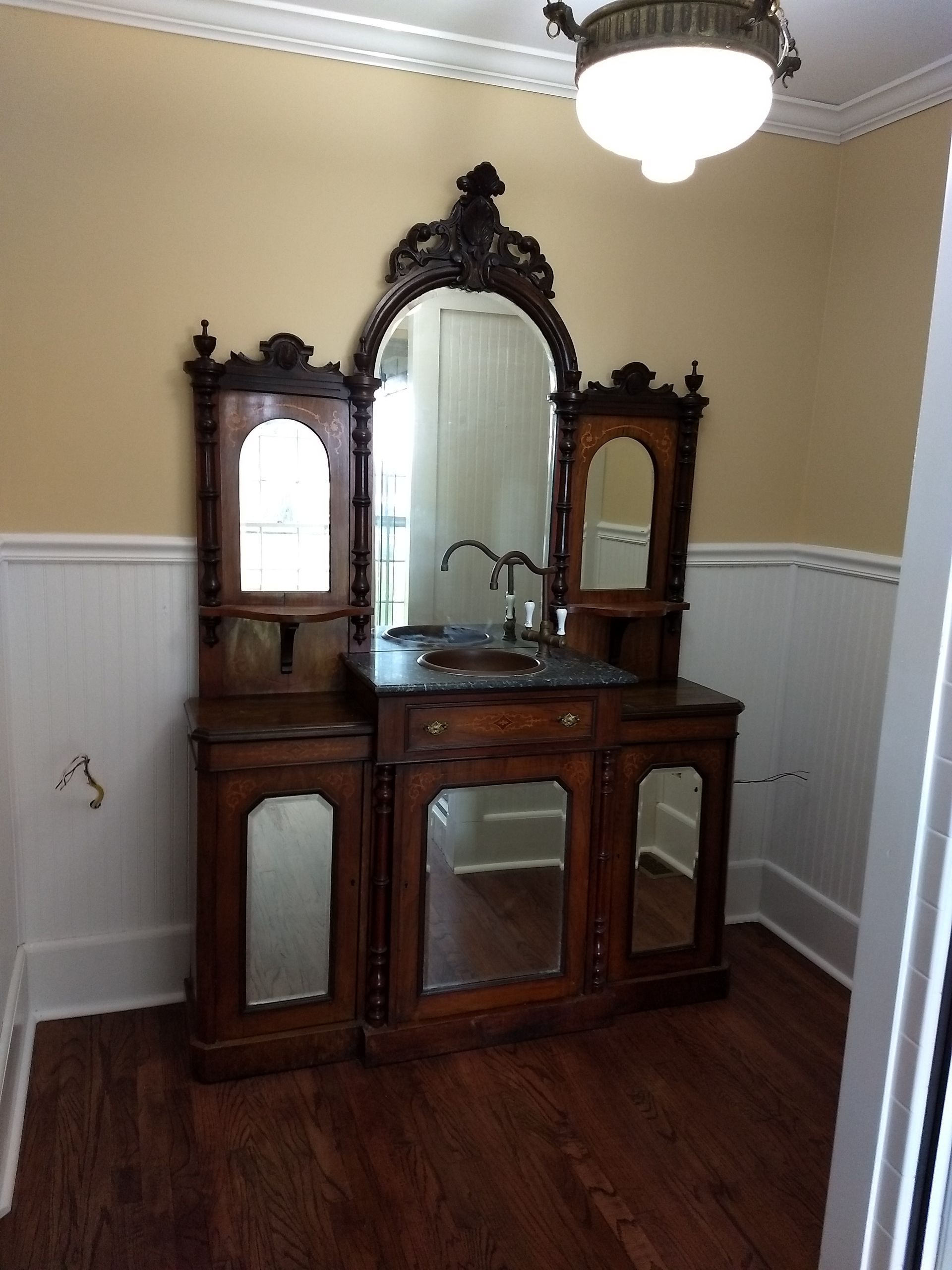 A bathroom with a large mirror and a sink