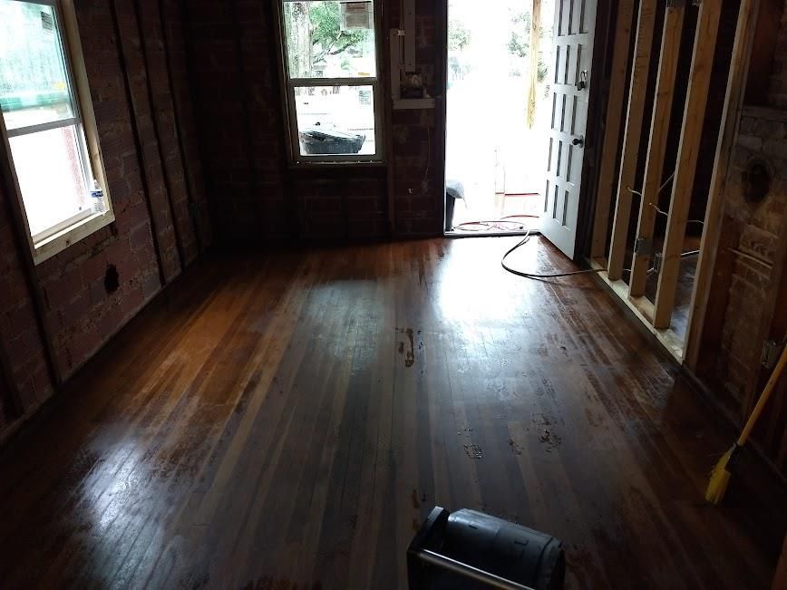 A room with a wooden floor and a window