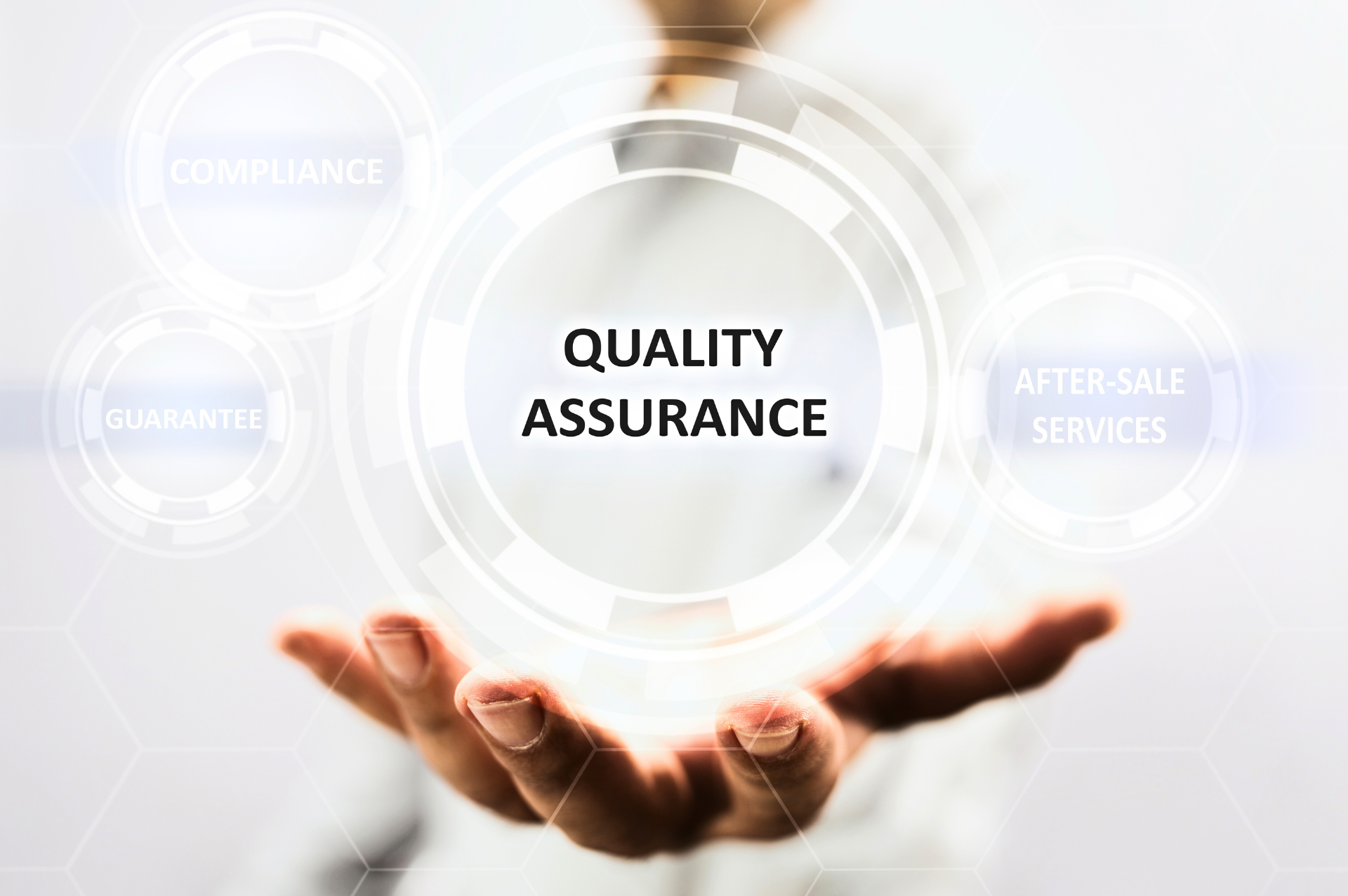 A person is holding a circle with the words quality assurance on it.
