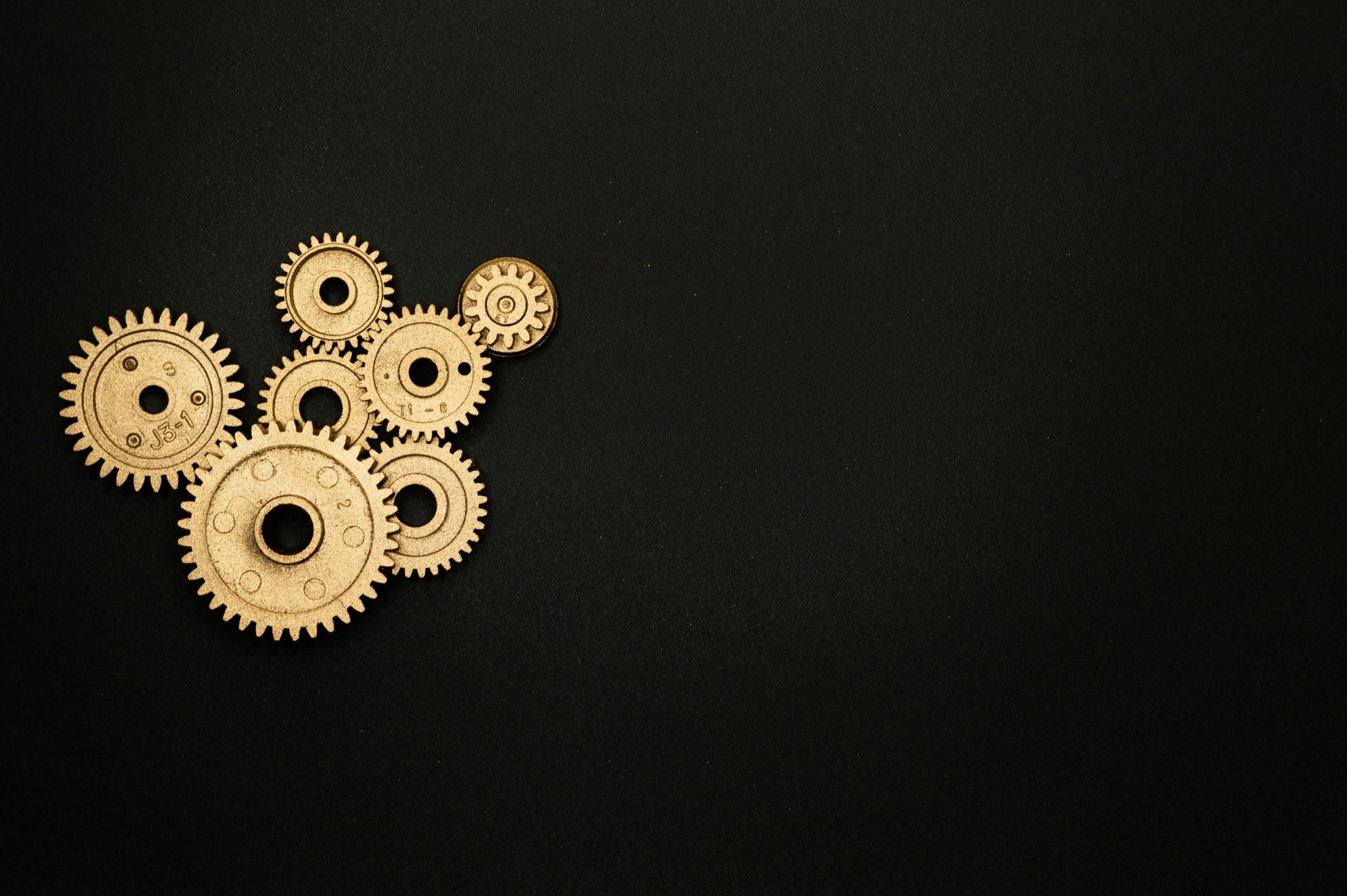 A group of wooden gears on a black background.