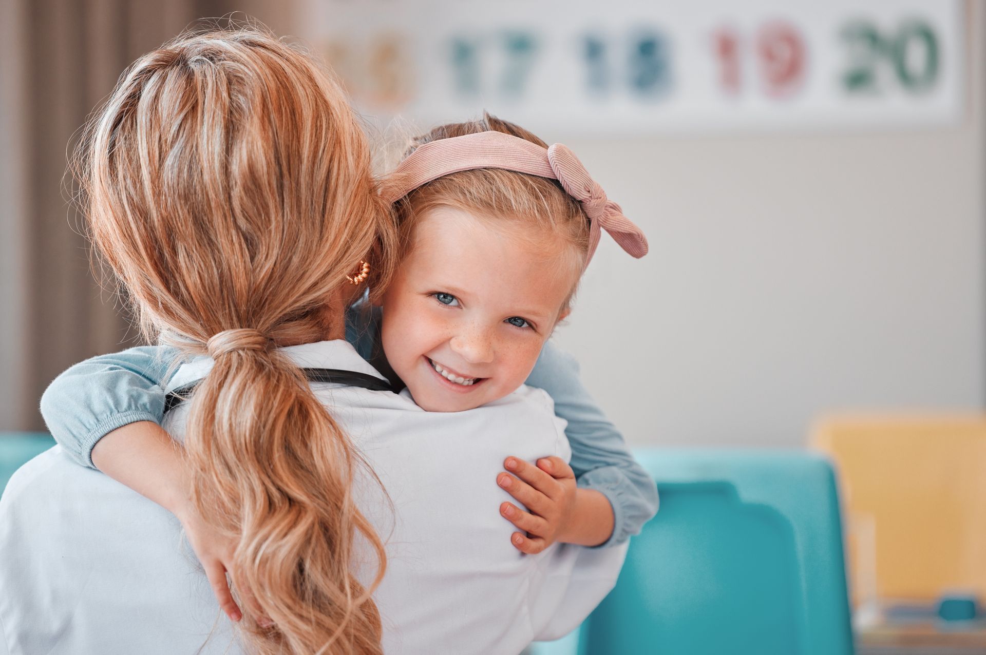A woman is holding a little girl in her arms.