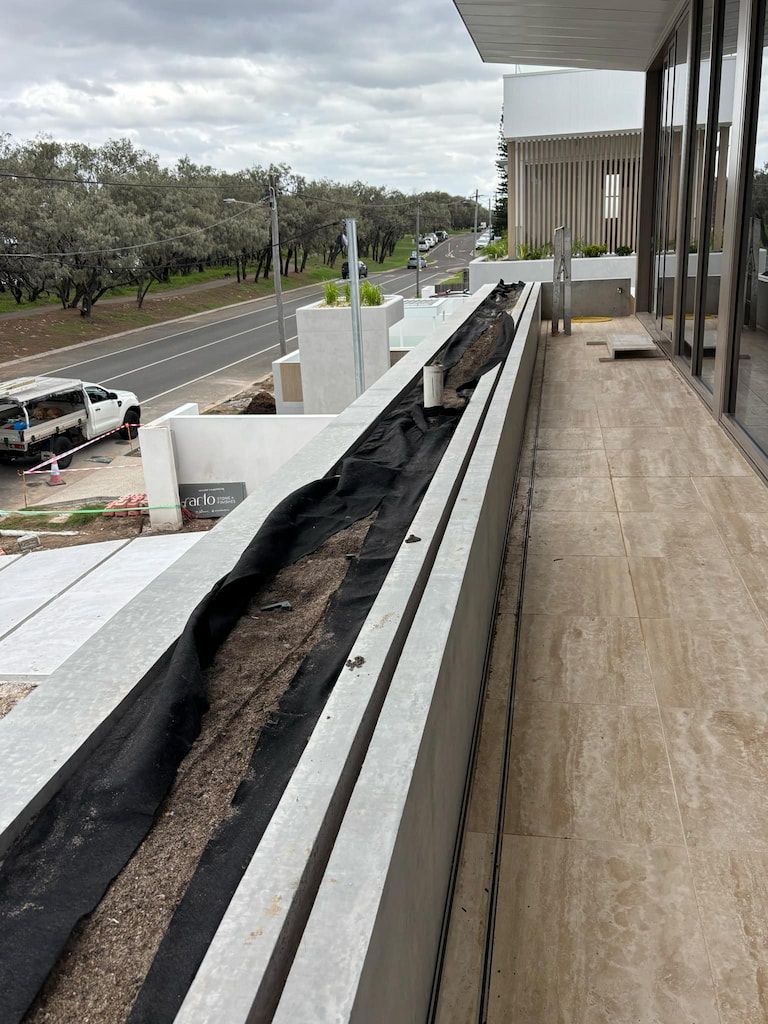 A balcony with a lot of windows and a road in the background.