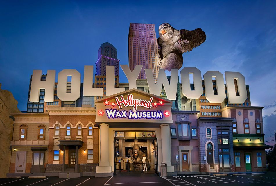Hollywood Wax Museum exterior, large Hollywood sign, building facades, a large flying gorilla, blue sky.