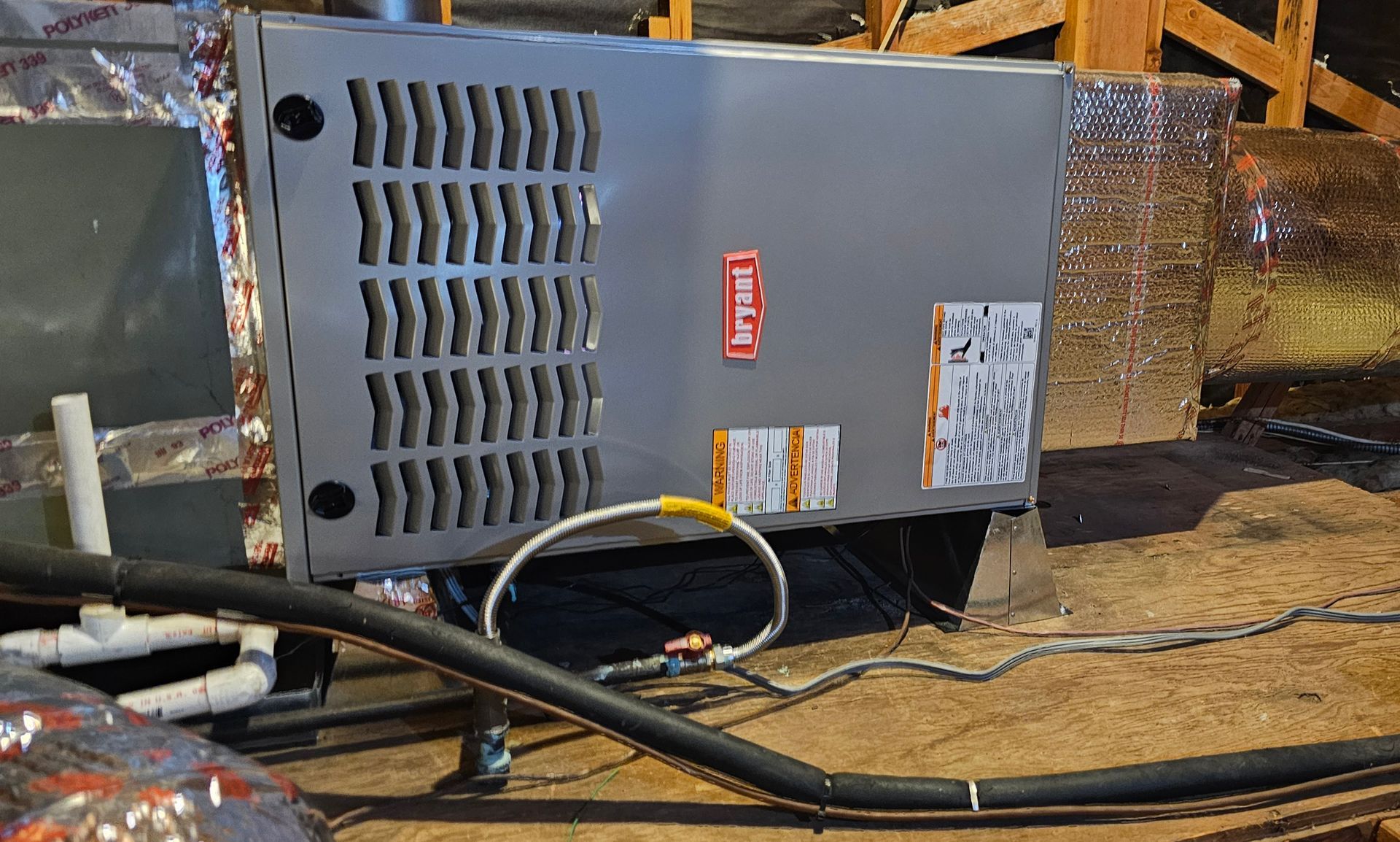 Gray industrial HVAC unit with vents and cables on a rooftop mechanical platform