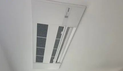Ceiling air vent and light fixture in a white room
