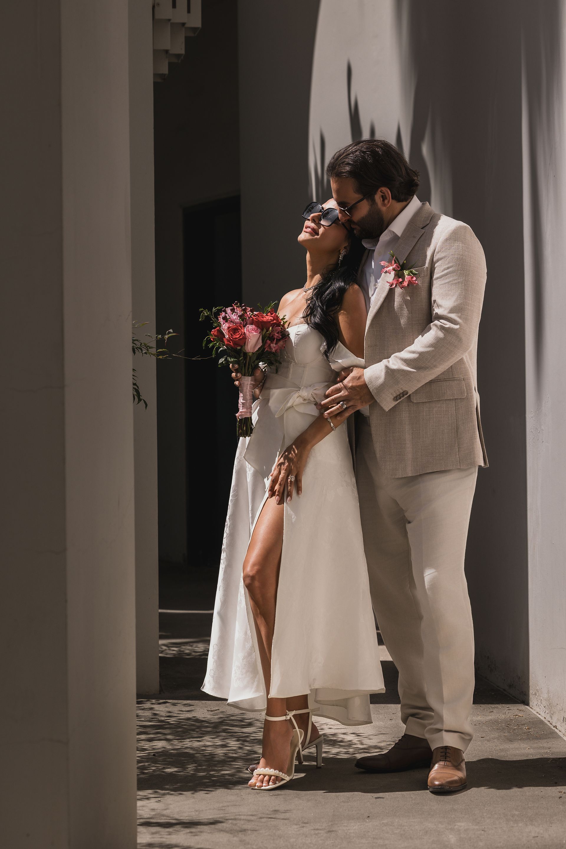 A bride and groom are posing for a picture on their wedding day.