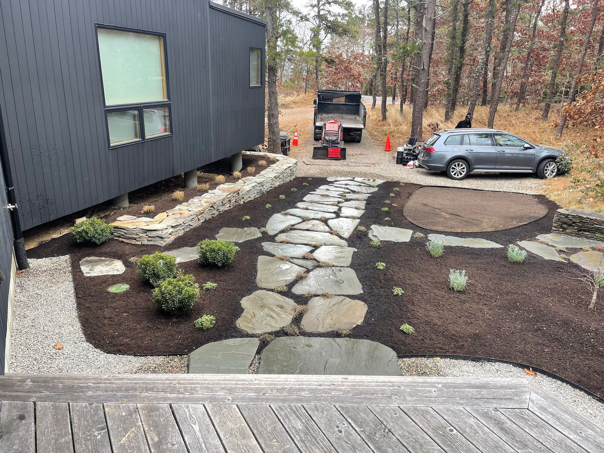 A car is parked in a driveway in front of a house.