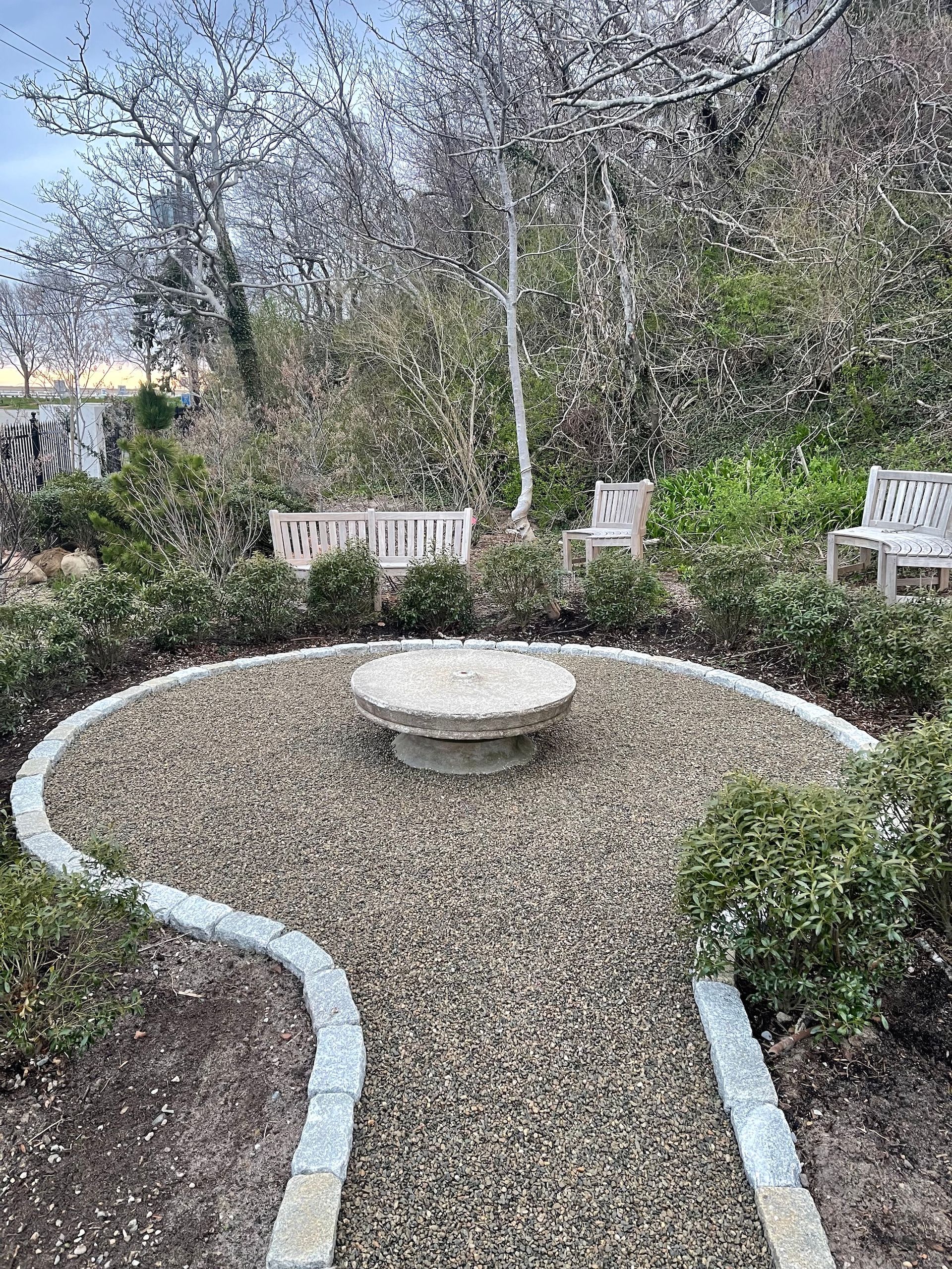 There is a fire pit in the middle of the garden.
