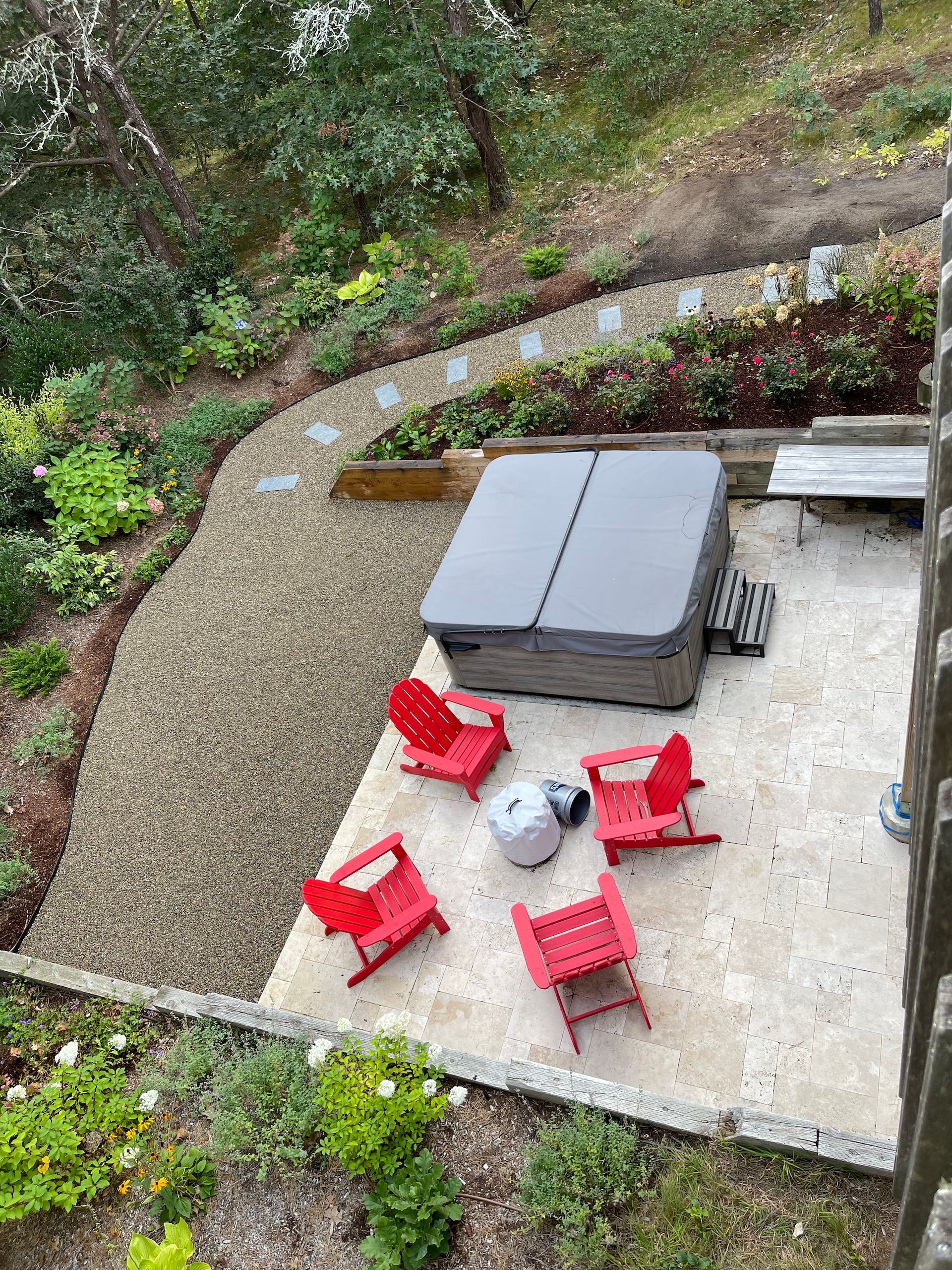 An aerial view of a patio with a hot tub and red chairs.
