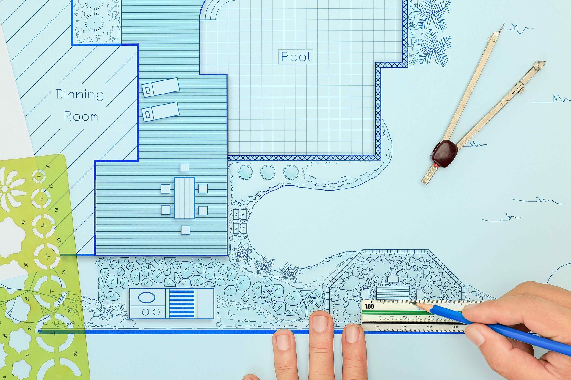 A landscape designer working on blueprint