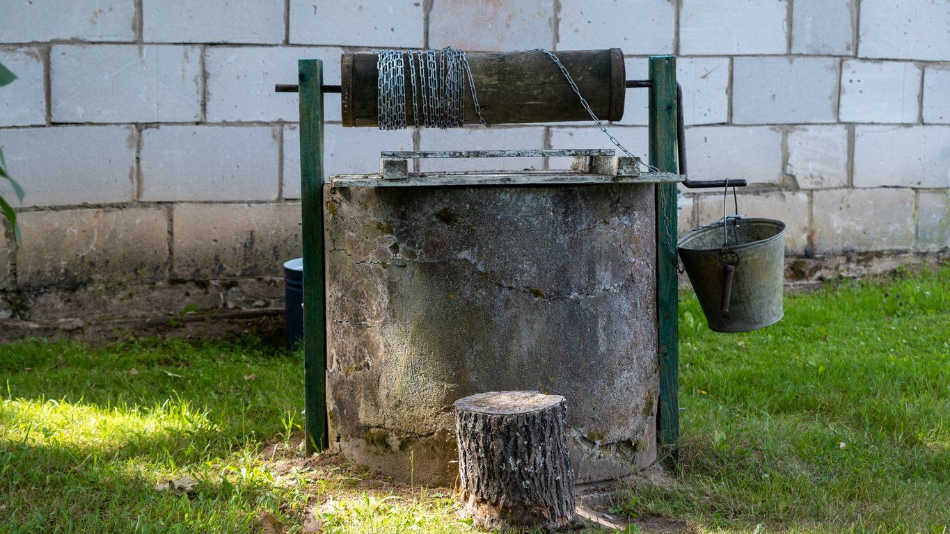 An old well outside the house. Well for drawing water located in the countryside.