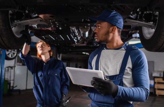Auto repair mechanics performing a pre-trip brake and tire inspection in New Brunswick, NJ.
