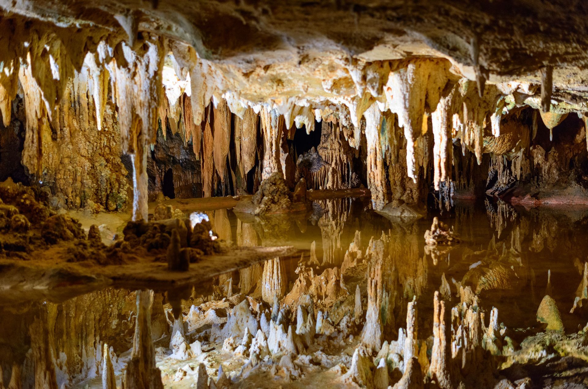 A cave filled with water and lots of stalagmites