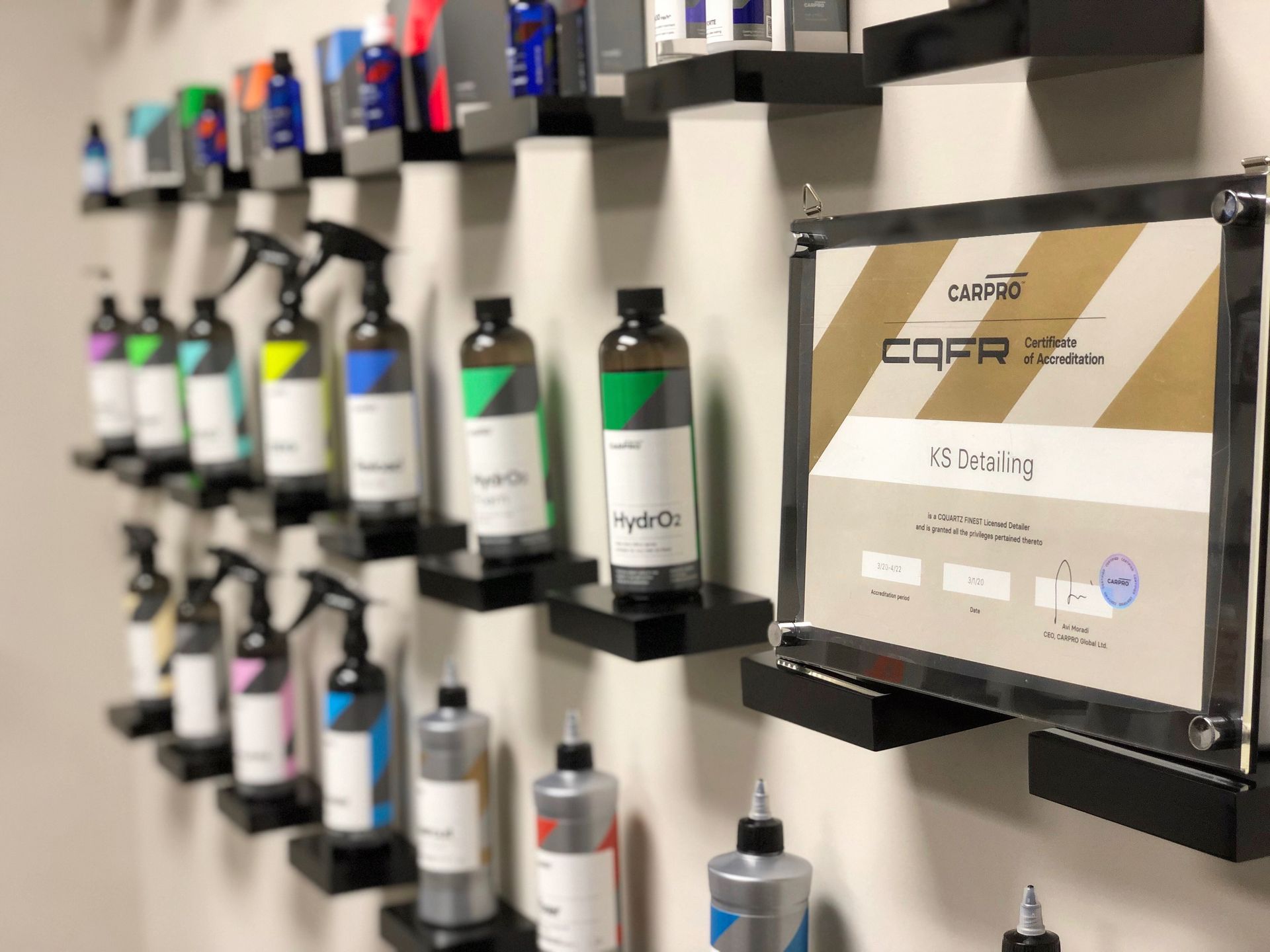 Shelves of assorted car care bottles, with a boxed product displayed on the right