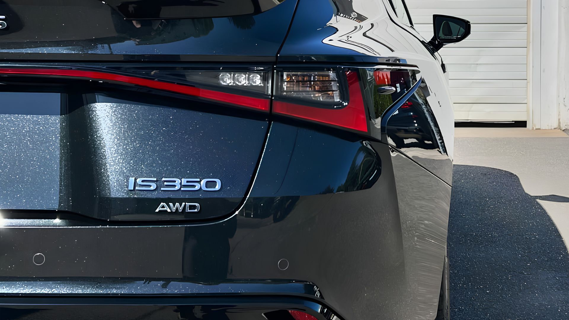 Rear of a dark blue Lexus IS 350 AWD parked in a driveway