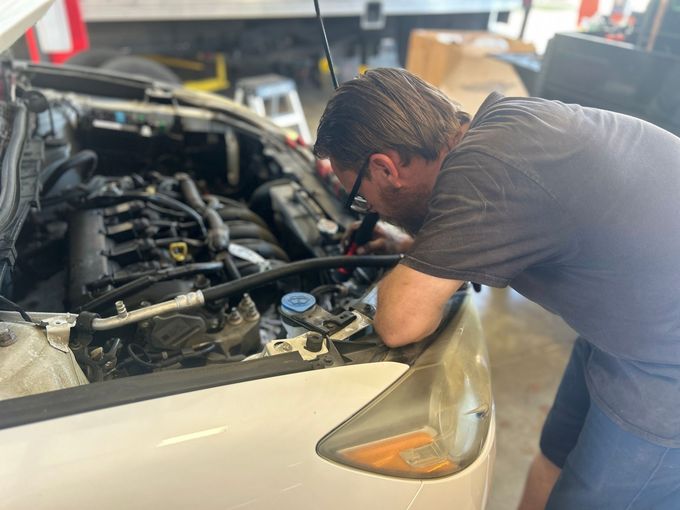 Mechanic Works on Car Engine | Hwy 59 Auto Repair