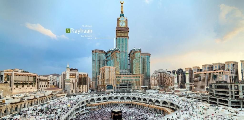 A panoramic view of the Grand Mosque in Mecca, Saudi Arabia, with the clock tower in the background.