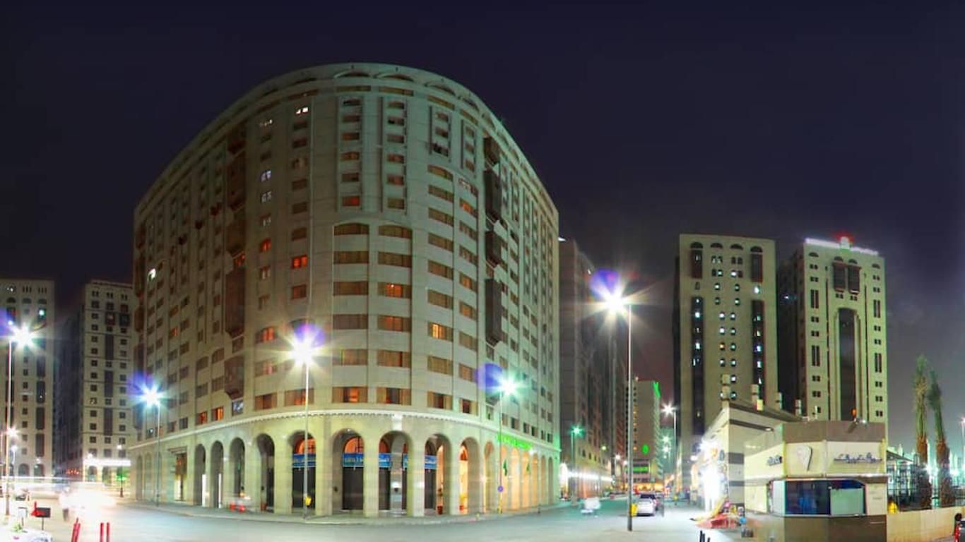 Night view of hotel buildings in a city, lit by streetlights.