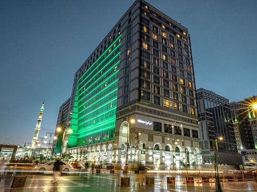Hotel in Medina, Saudi Arabia, illuminated at night with green lights.