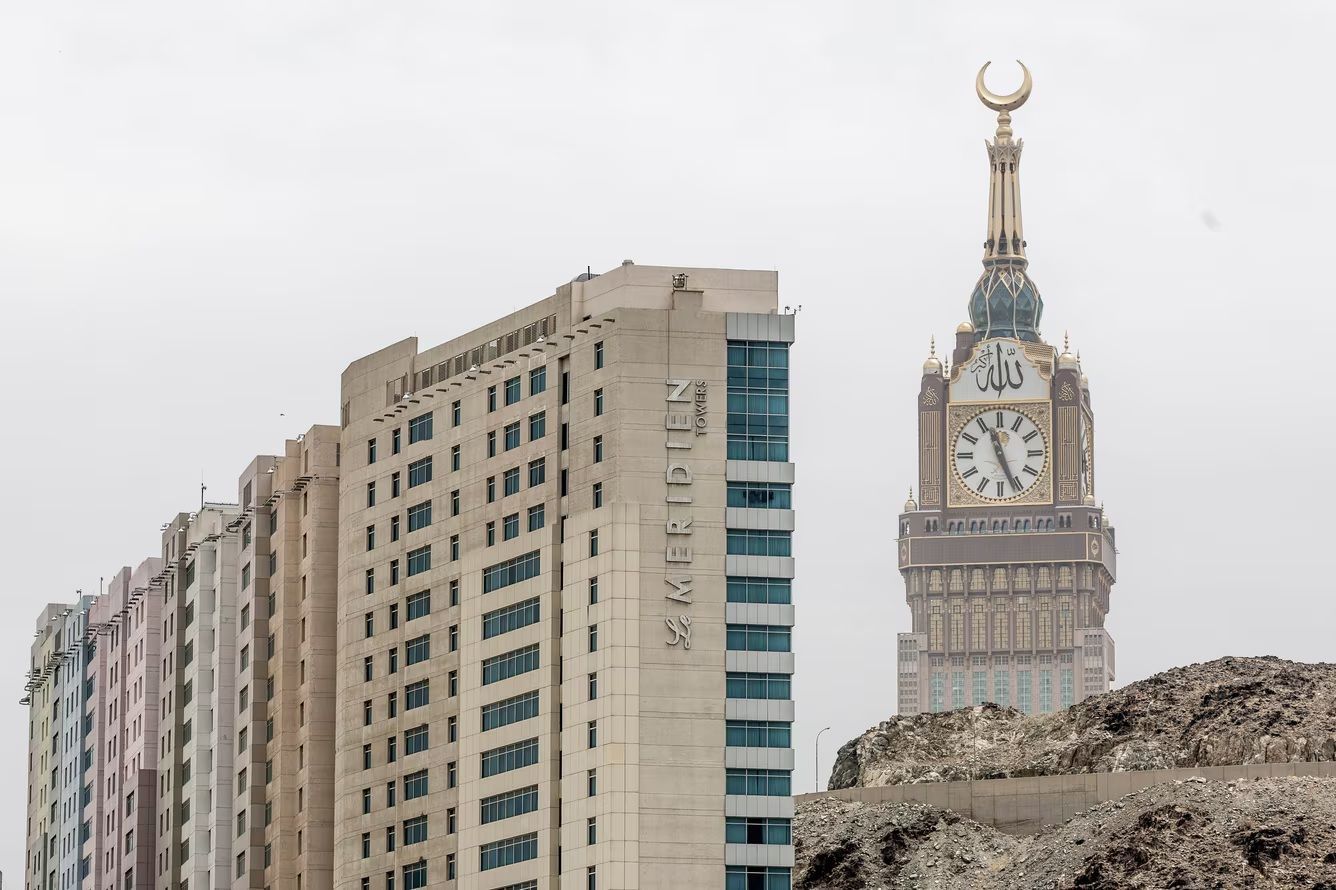 Modern buildings and clock tower with a crescent moon atop, Mecca, Saudi Arabia.