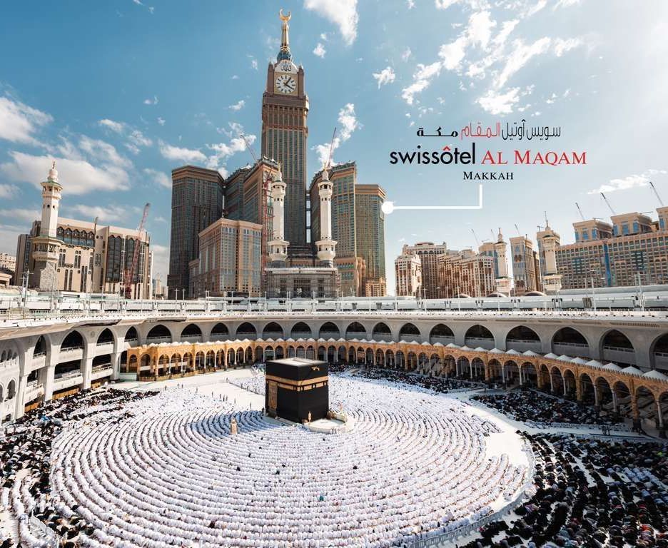 Kaaba in Mecca, Saudi Arabia, surrounded by pilgrims, with Swissôtel Al Maqam in the background.