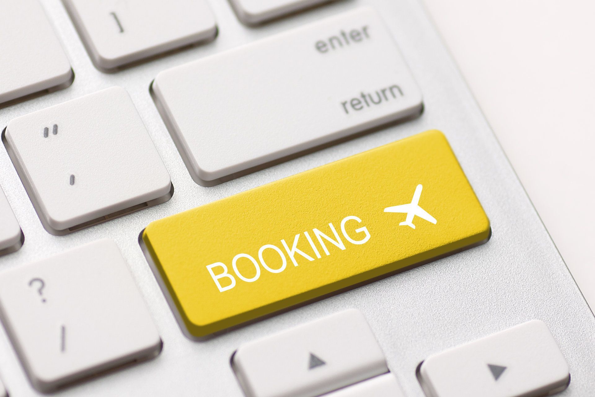 A yellow button on a keyboard that says booking