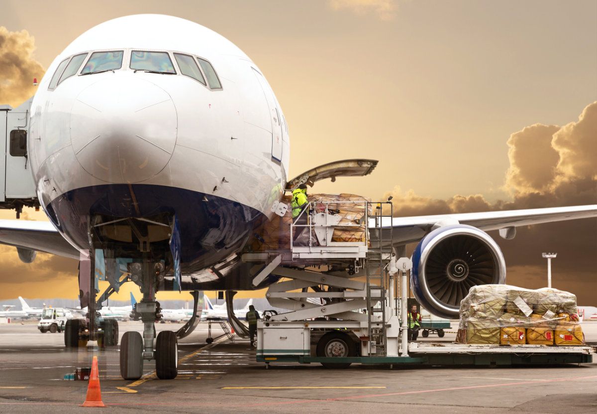 An airplane is being loaded with cargo at an airport
