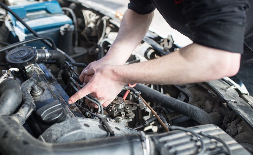 Person Working on a Car Engine; Pointing at a Part — A.M.D. Automotive Services in Mackay, QLD