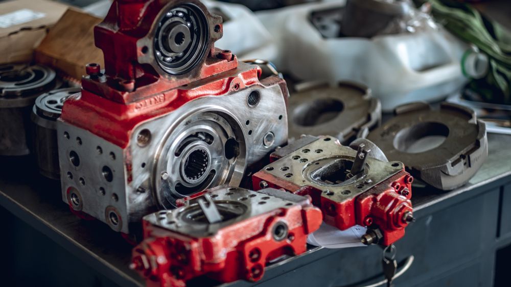 Disassembled Red and Silver Machinery Parts on a Workbench — A.M.D. Automotive Services in Bowen, QLD
