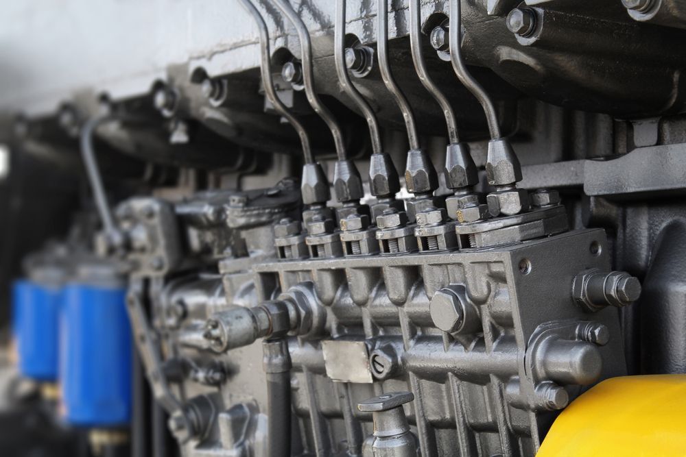 Close-up of a Dark Grey Engine With Multiple Tubes and Pipes — A.M.D. Automotive Services in Mackay, QLD