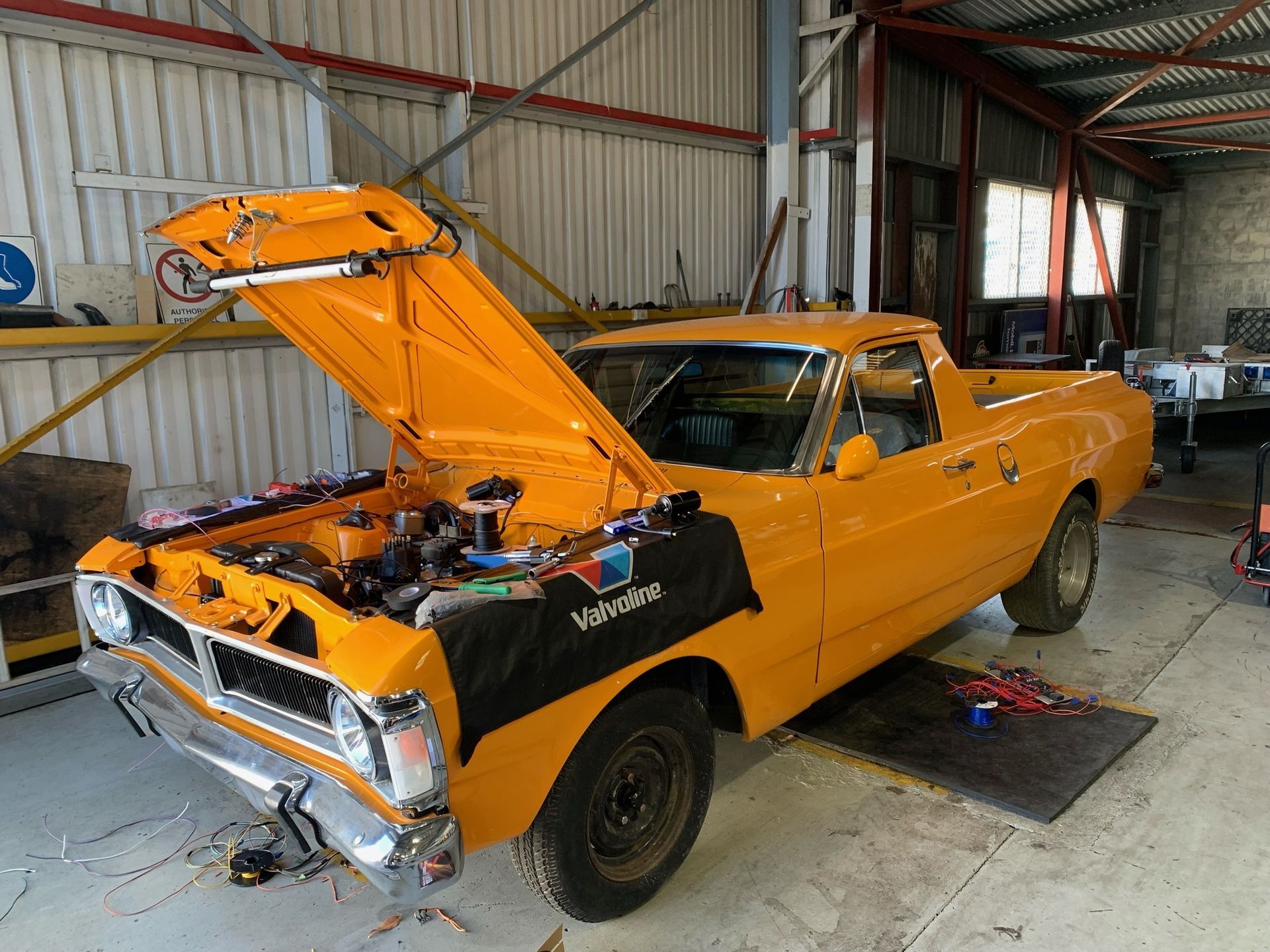 Yellow Classic Ford Utility Truck in a Garage, Hood Open for Repairs — A.M.D. Automotive Services in Mackay, QLD