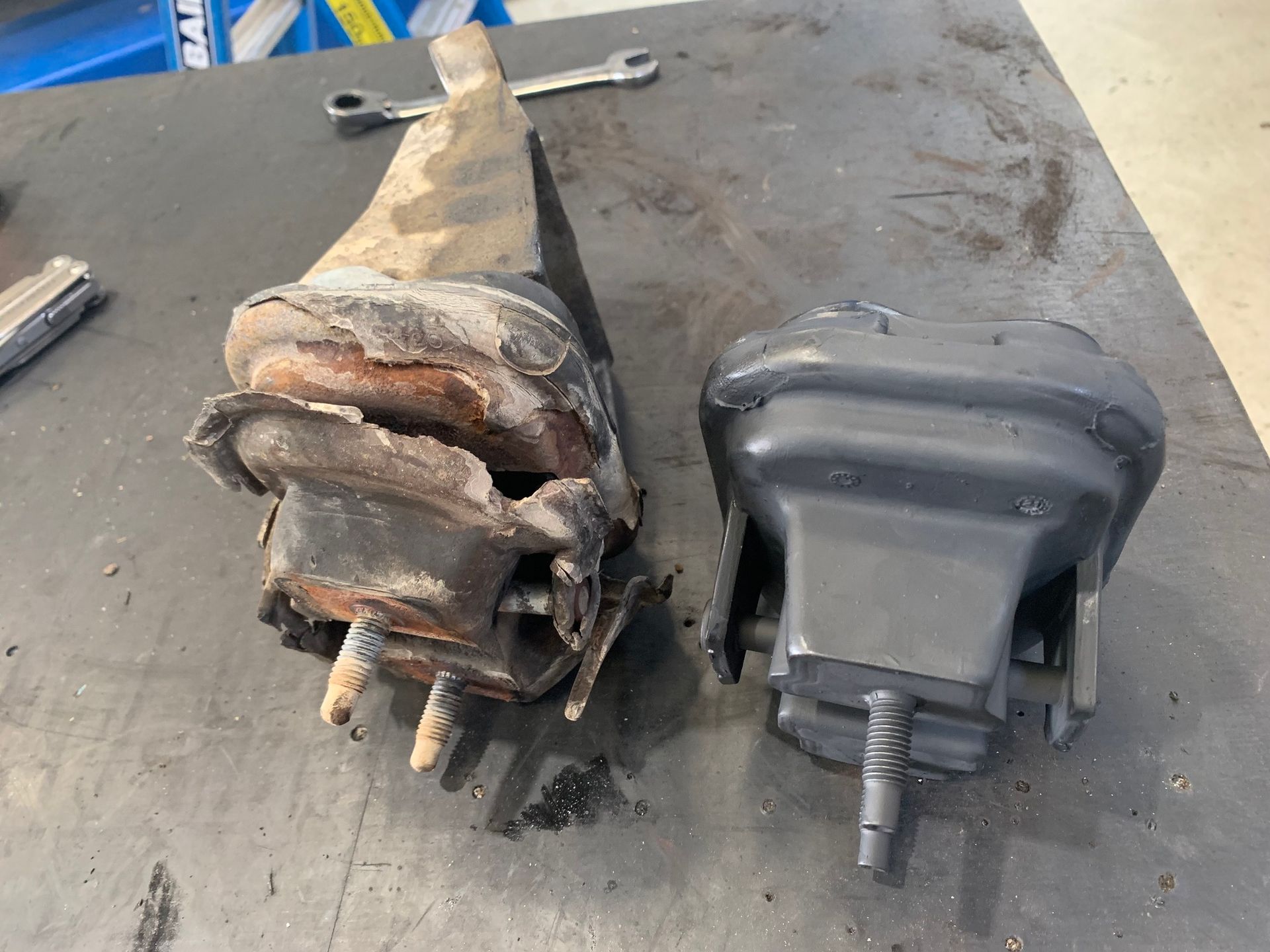 Old and New Car Engine Mounts Side by Side on a Workbench — A.M.D. Automotive Services in Proserpine, QLD