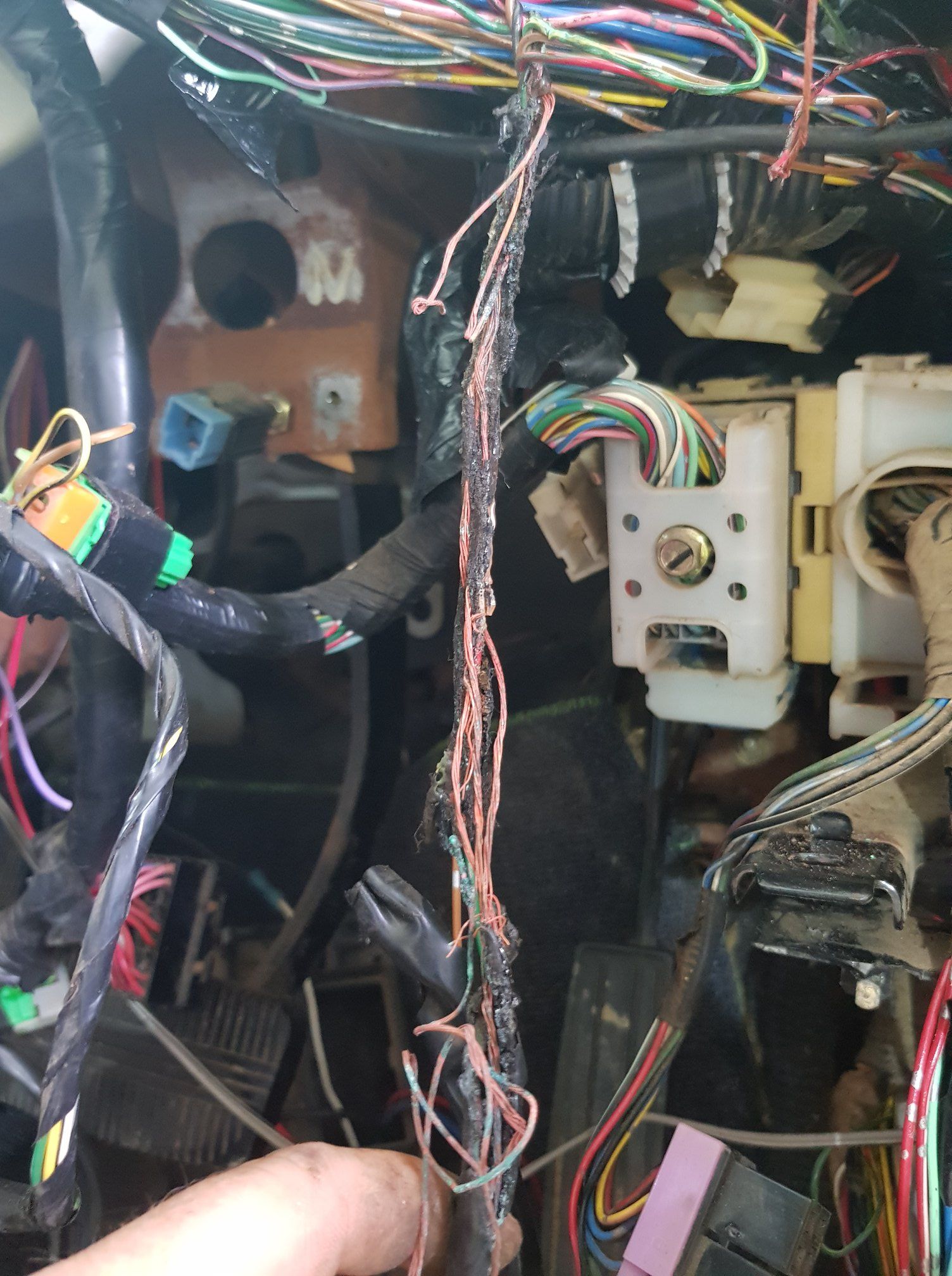 Damaged Car Wiring Harness With Frayed Wires in a Vehicle Dashboard — A.M.D. Automotive Services in Mackay, QLD