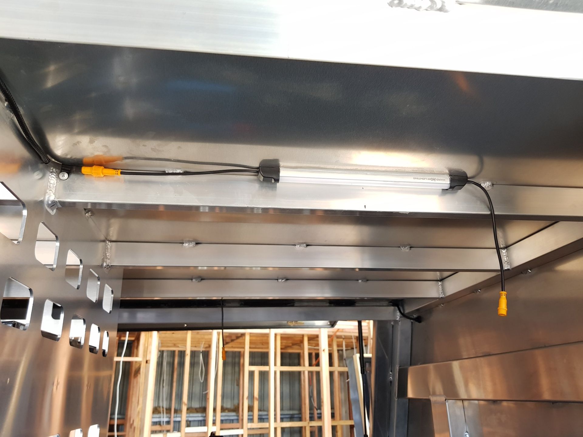 Fluorescent Light Fixture Installed Inside a Metal Structure, Wiring Visible — A.M.D. Automotive Services in Bowen, QLD