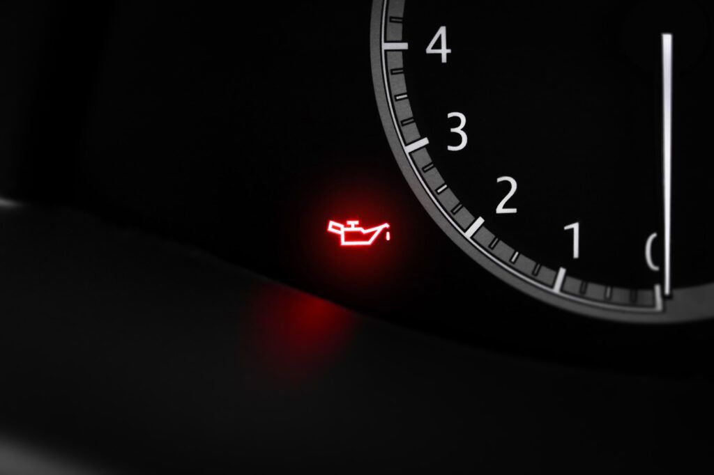 Red Oil Pressure Warning Light Illuminated on a Car Dashboard — A.M.D. Automotive Services in Mackay, QLD