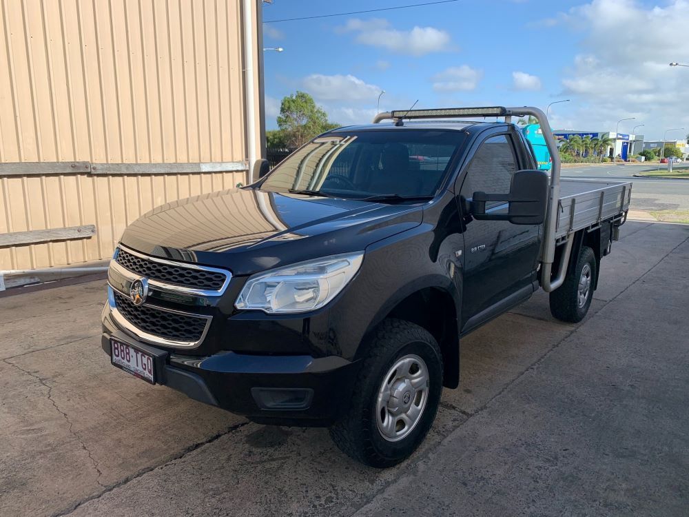 Black Chevrolet Colorado Pickup Truck With a Flatbed in Front of a Building — A.M.D. Automotive Services in Mackay, QLD