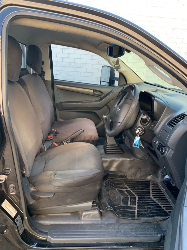 Black Truck Interior With Driver's Seat, Steering Wheel, and Floor Mats — A.M.D. Automotive Services in Mackay, QLD