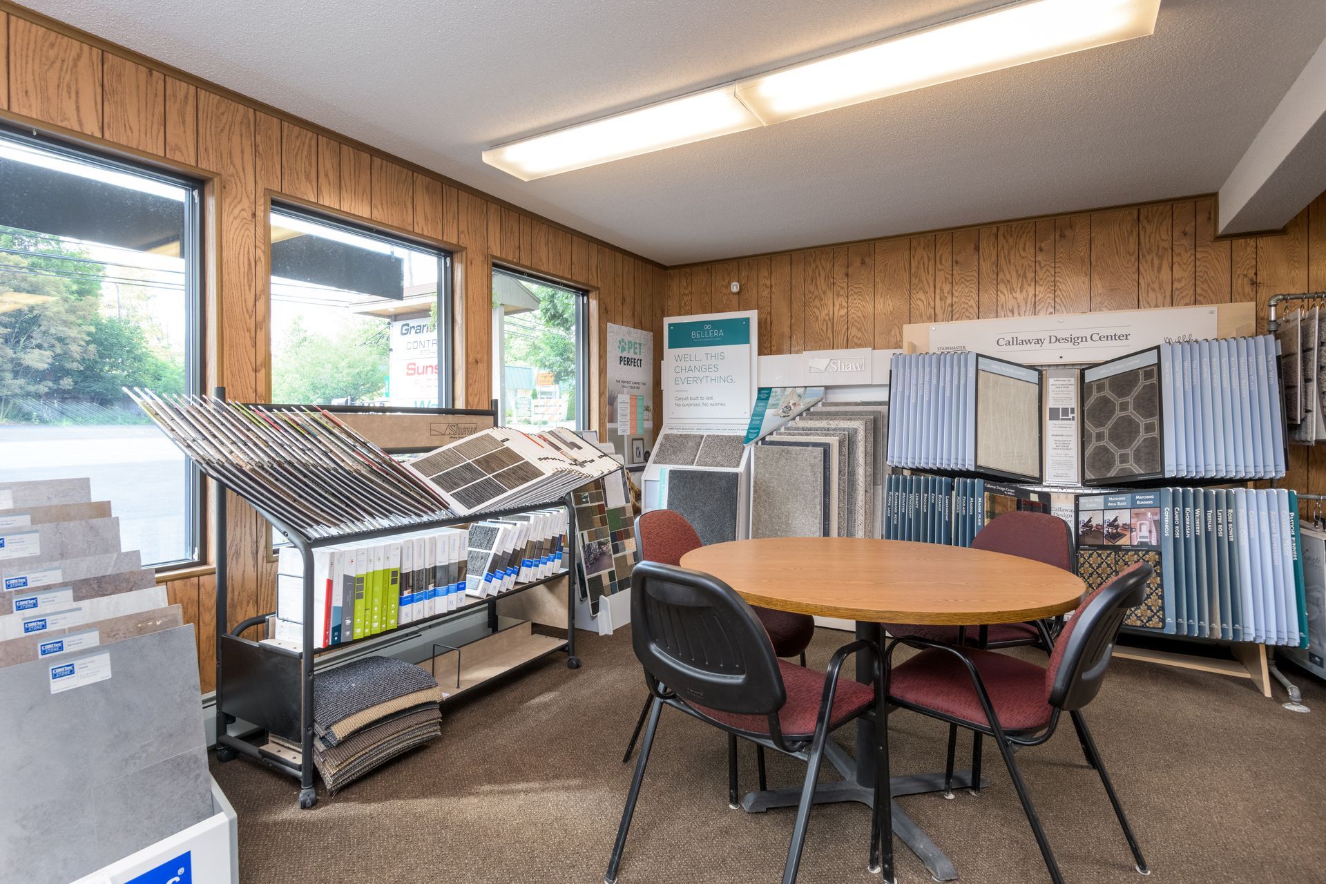 There is a table and chairs in the middle of the room.