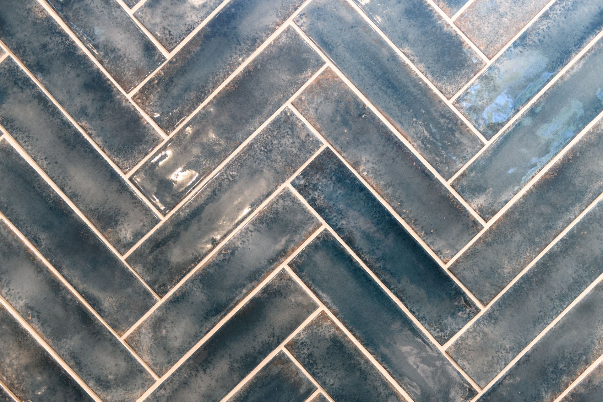A close up of a herringbone pattern on a tile floor.