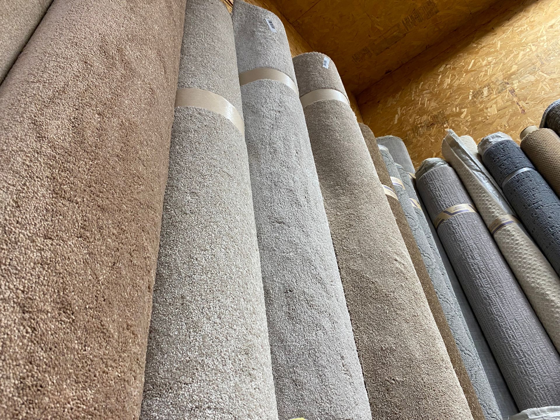 A bunch of rolls of carpet are stacked on top of each other.