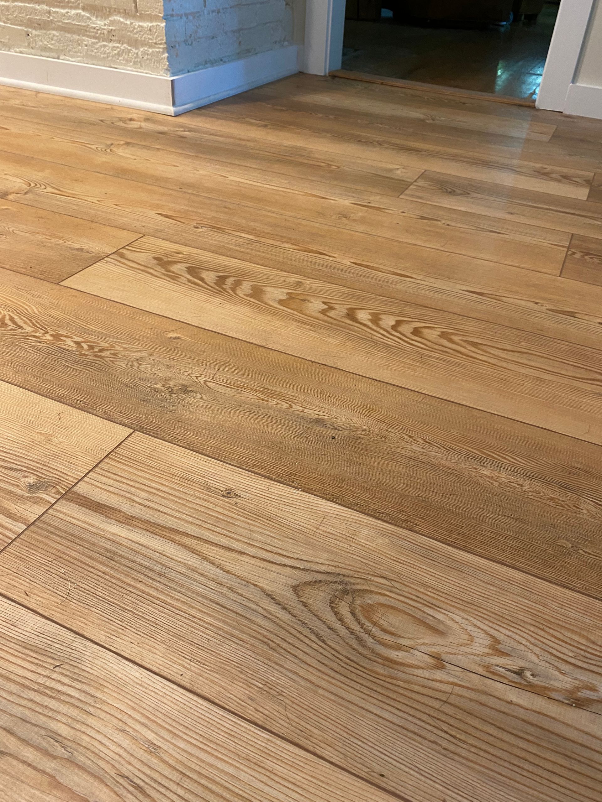 A close up of a wooden floor in a room.
